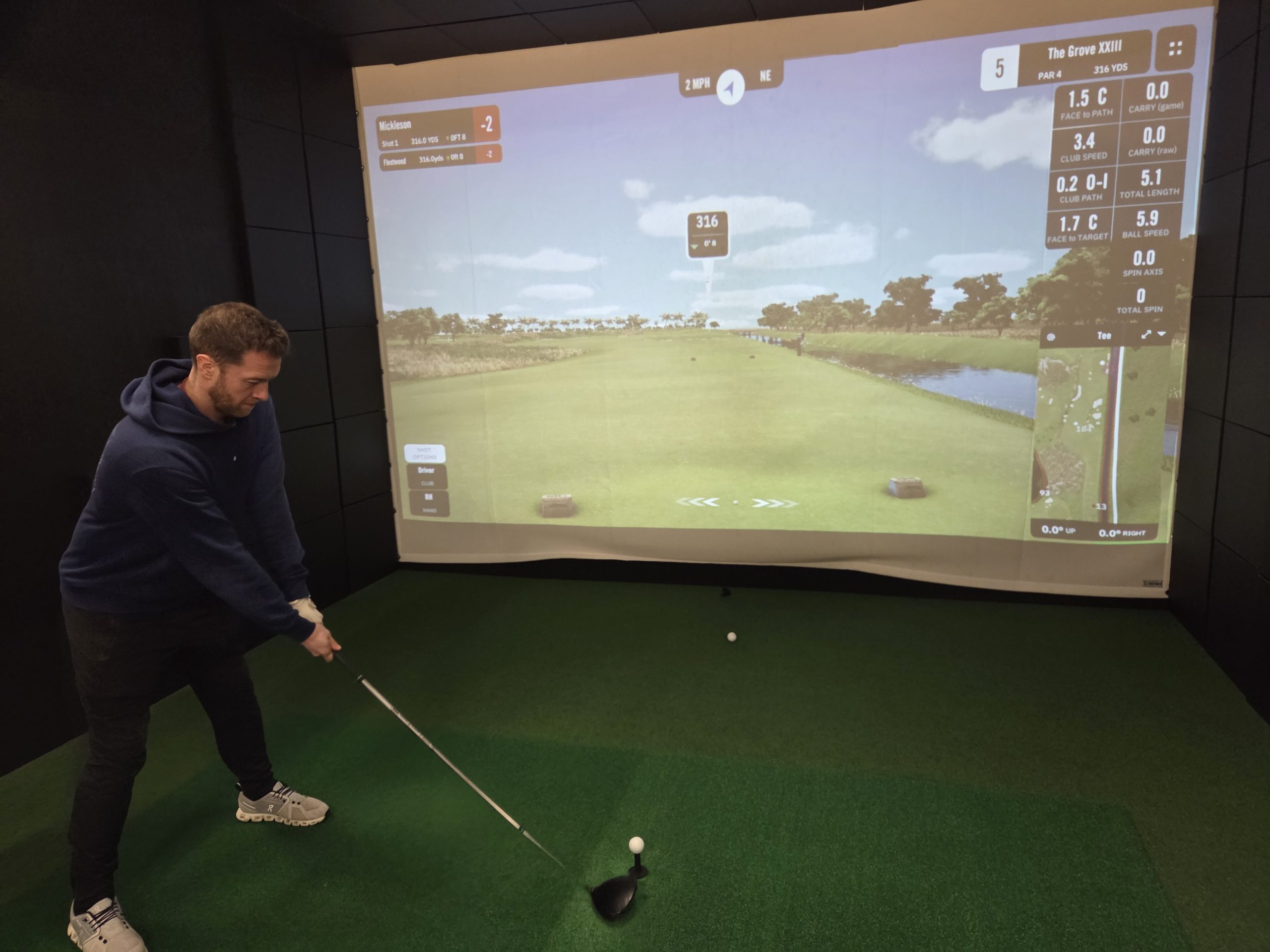 Inside Birdie Bays - oak barrel tables and simulator bays