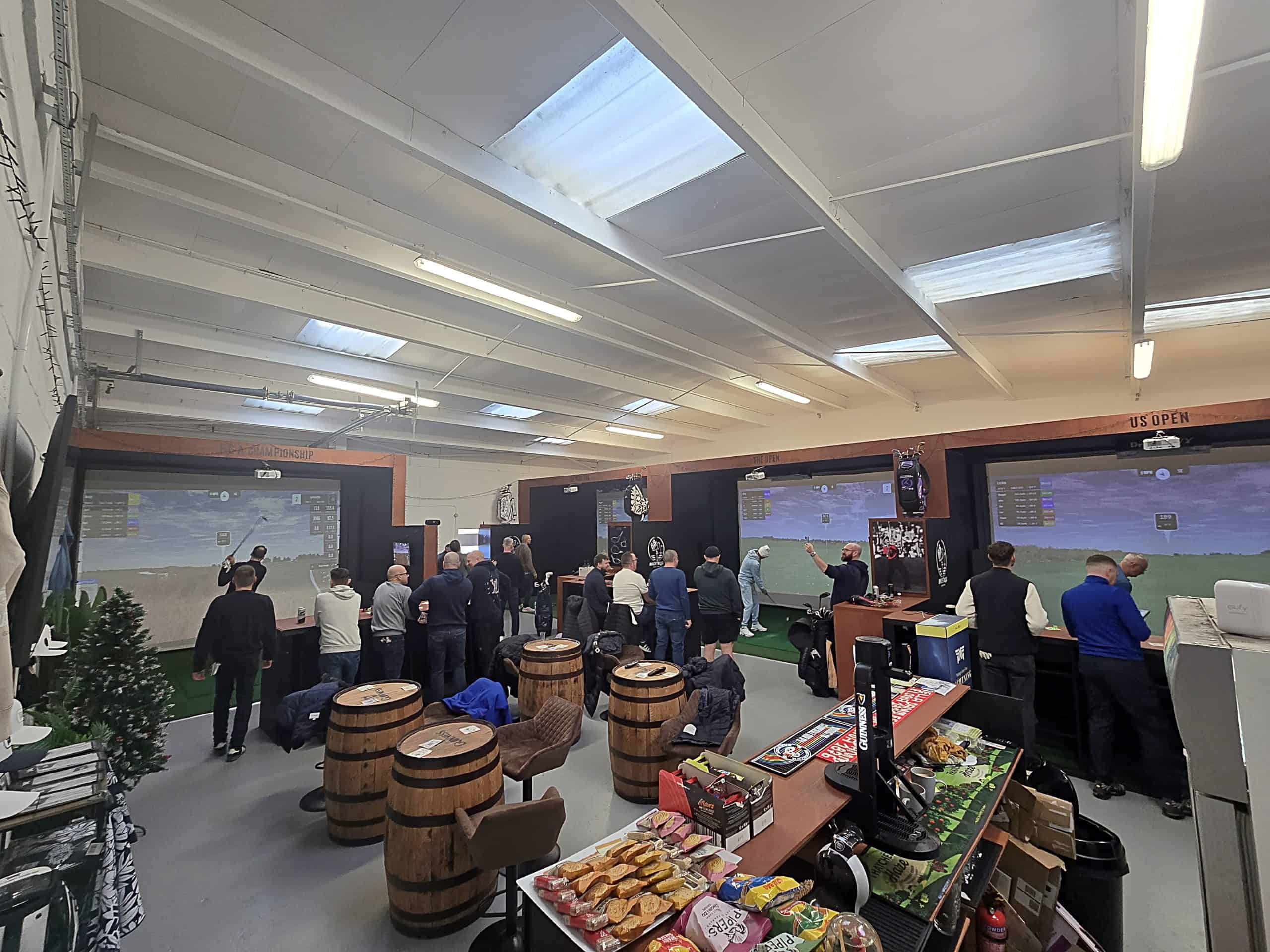 Birdie Bays venue space with group enjoying golf simulator
